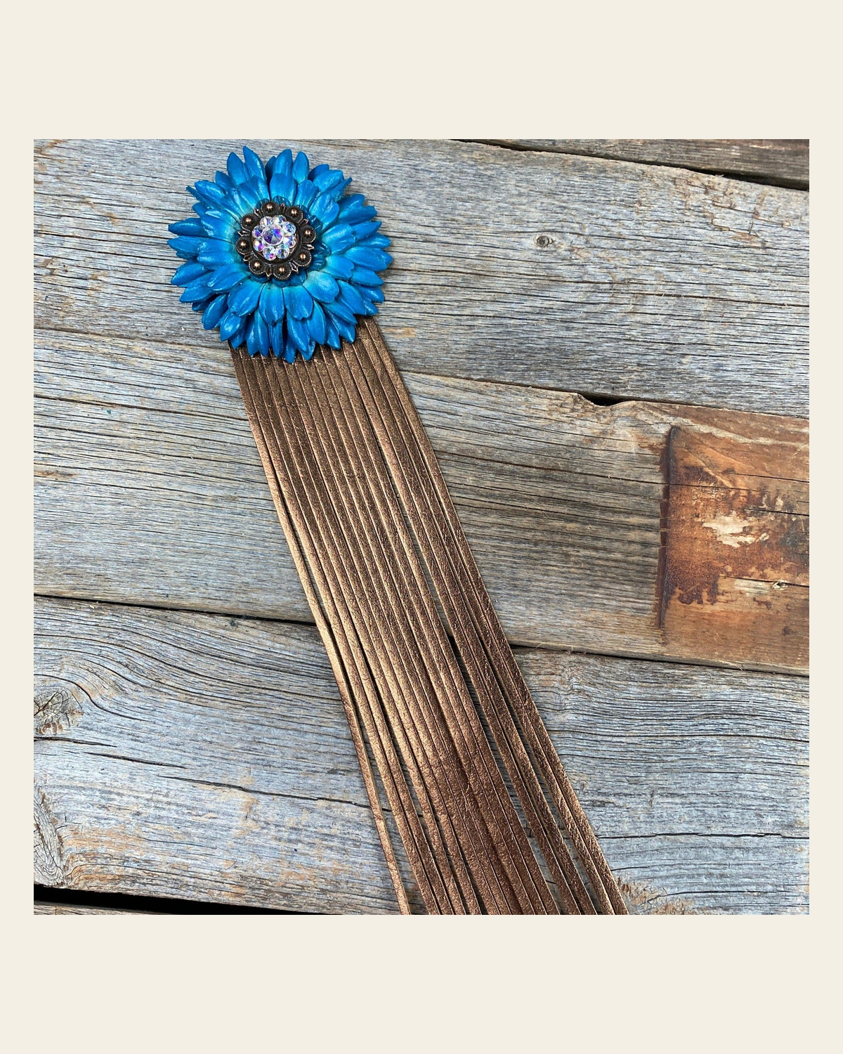 Leather Turquoise Daisy with Copper Fringe on a warm cream background