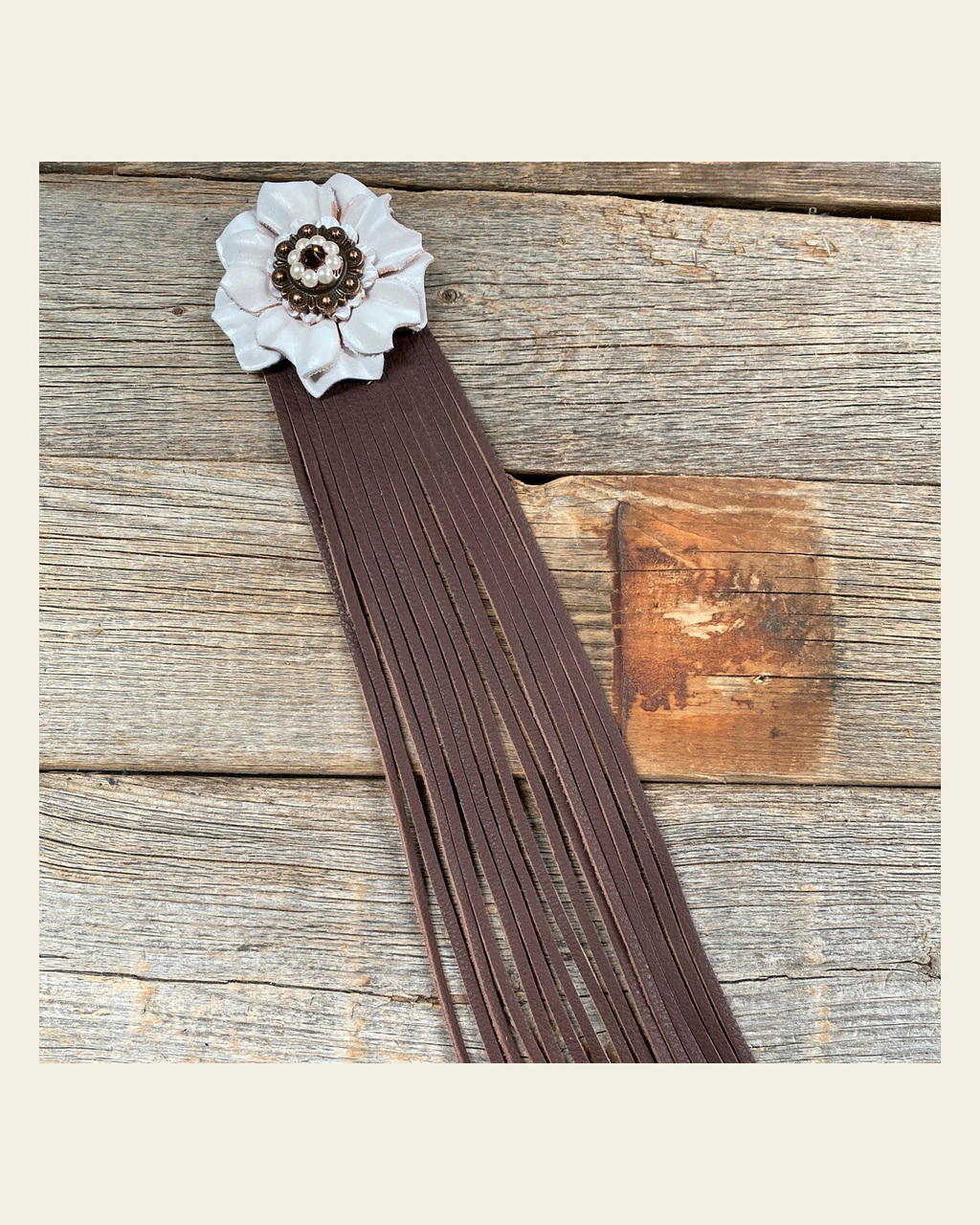 Leather White Carnation with Brown Fringe on a warm cream background