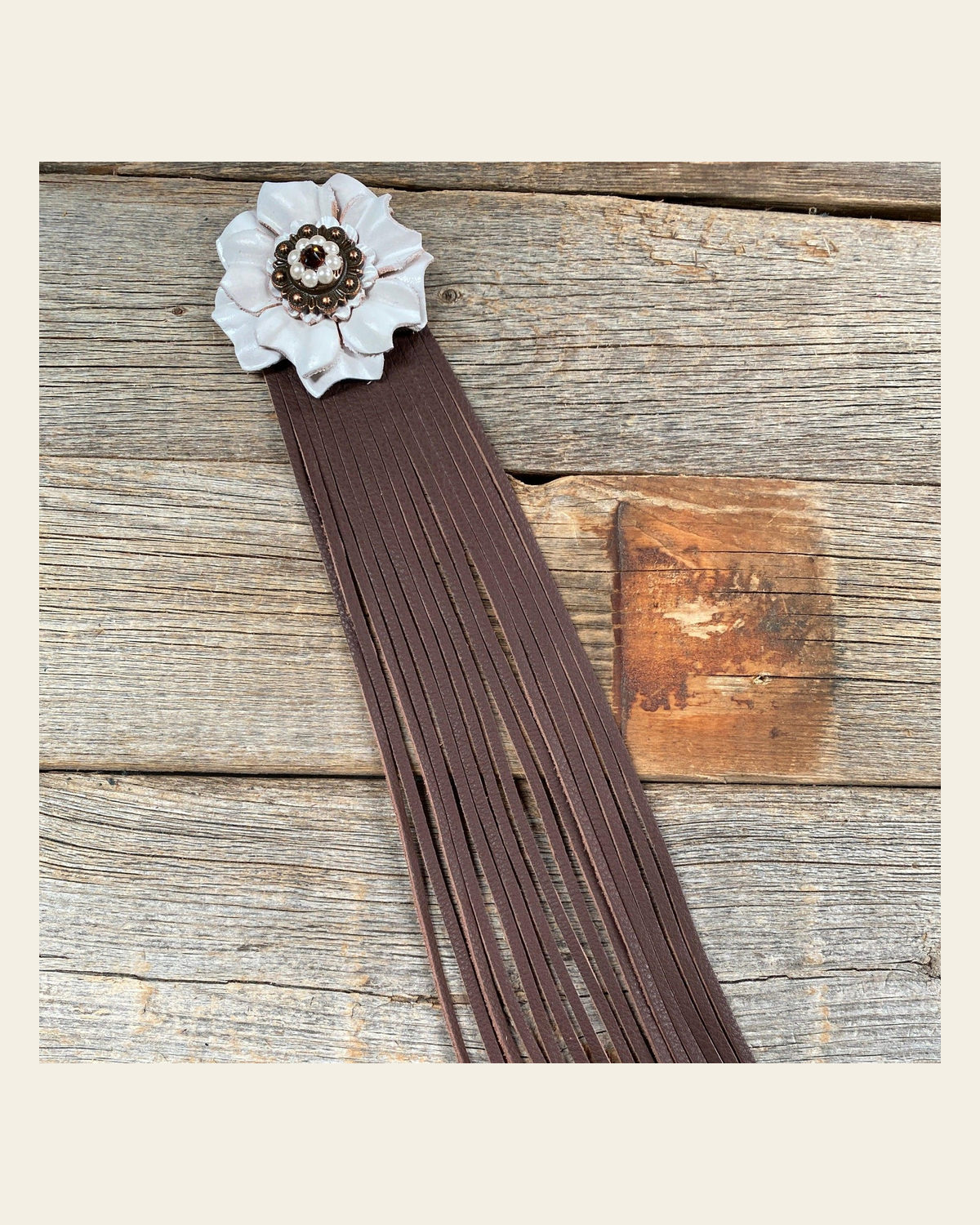 Leather White Carnation with Brown Fringe on a warm cream background