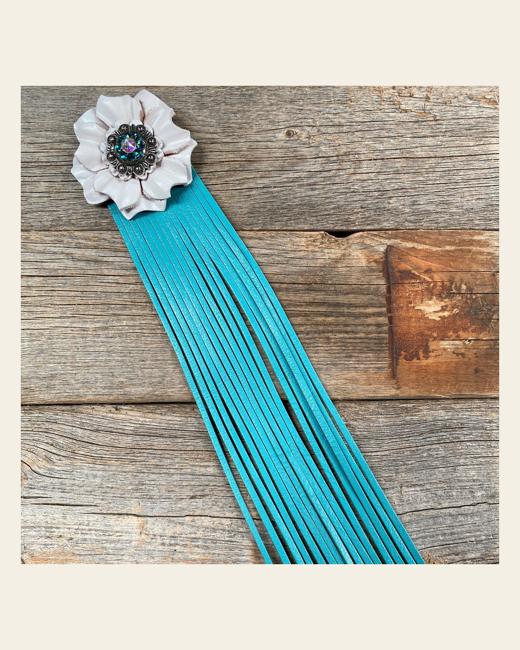 Leather White Carnation with Turquoise Fringe on a warm cream background