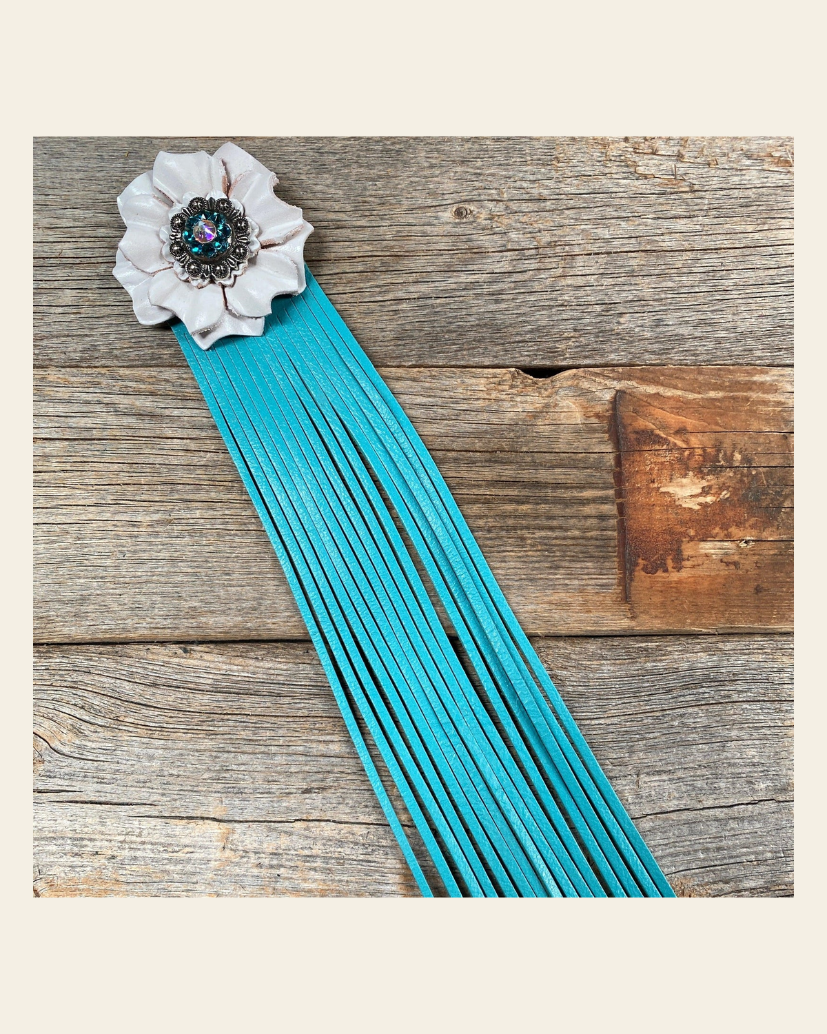 Leather White Carnation with Turquoise Fringe on a warm cream background
