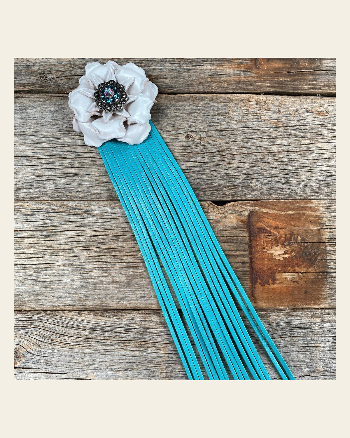 Leather White Gardenia with Turquoise Fringe on a warm cream background