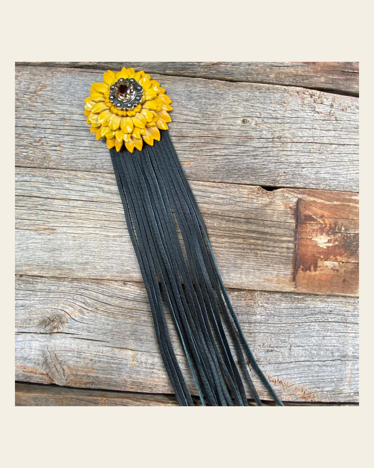 Leather Yellow Daisy with Black Fringe on a warm cream background