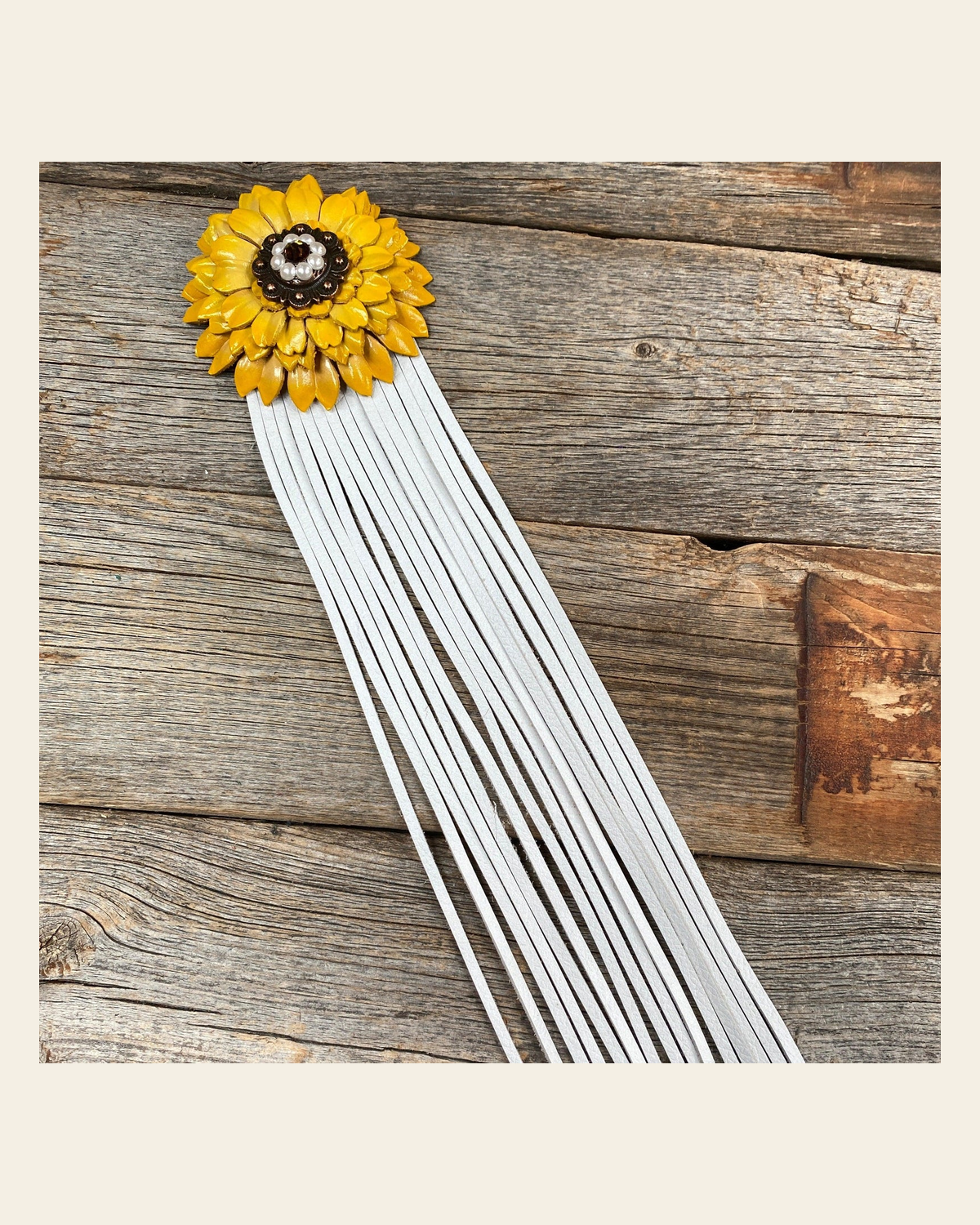 Leather Yellow Daisy with White Fringe on a warm cream background