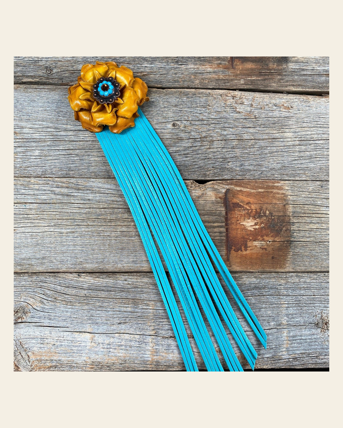 Leather Yellow Gardenia with Turquoise Fringe on a warm cream background