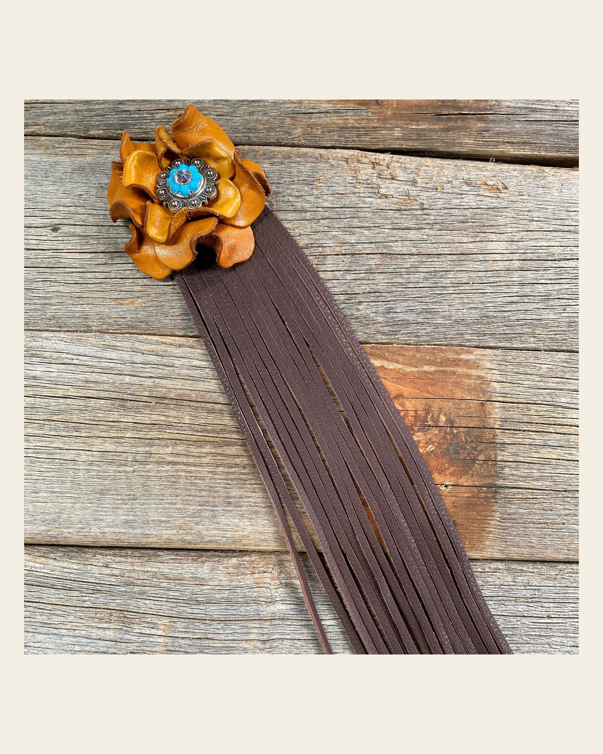 Leather Yellow Rose with Brown Fringe on a warm cream background