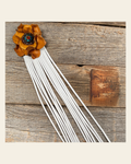 Leather Yellow Rose with White Fringe on a warm cream background