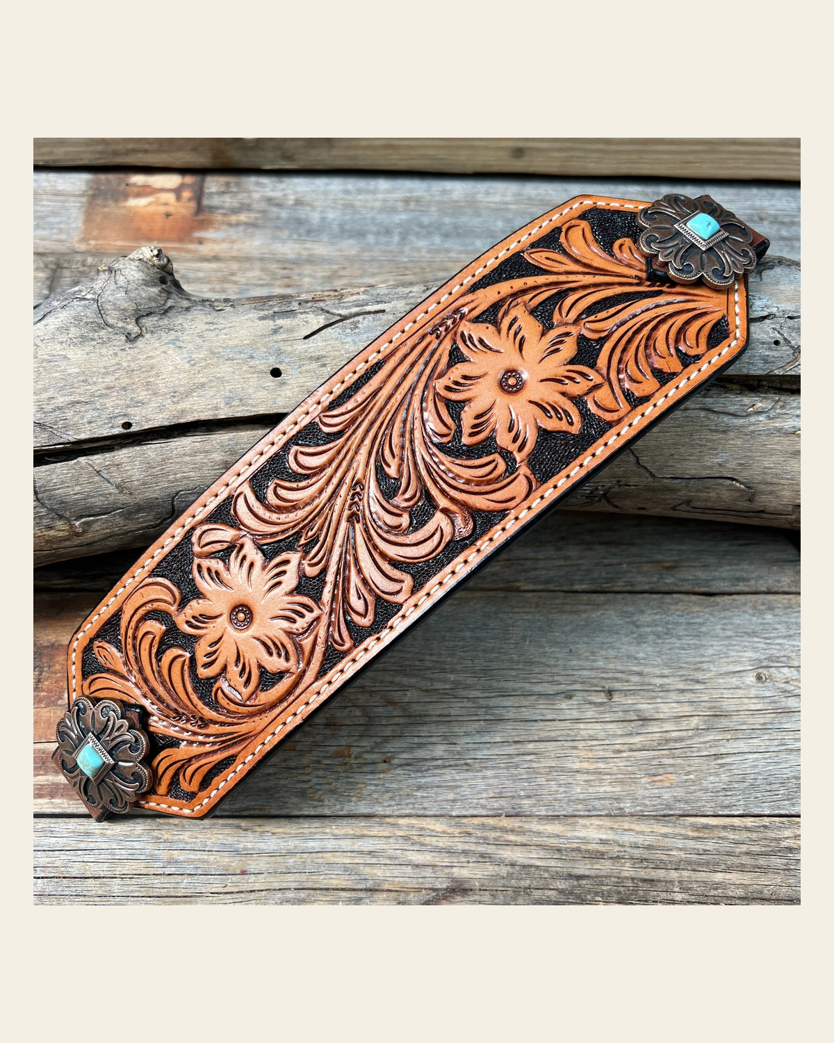 Light Oil Floral Bronc Noseband With Copper Fleur-De-Lis Conchos on a warm cream background