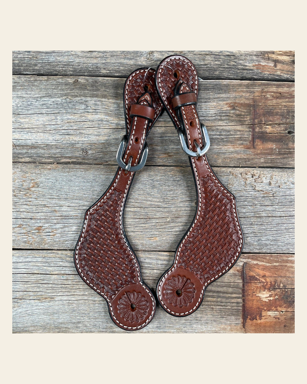 Medium Oil Genuine Leather Basketweave Tooled Spur Straps on a warm cream background