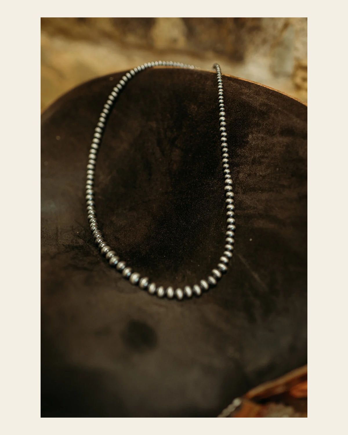 Navajo Inspired 24" Graduated Pearl Sterling Silver Necklace on a warm cream background