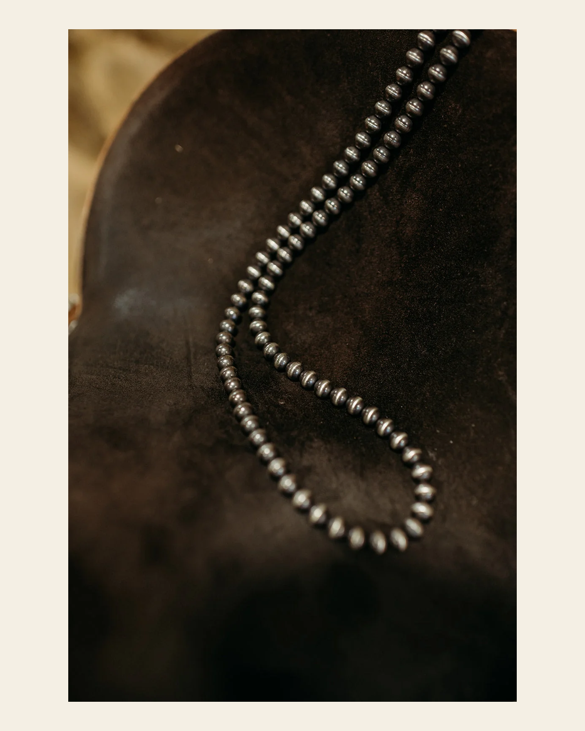 Navajo Inspired 36" 8MM Pearl Sterling Silver Necklace on a warm cream background