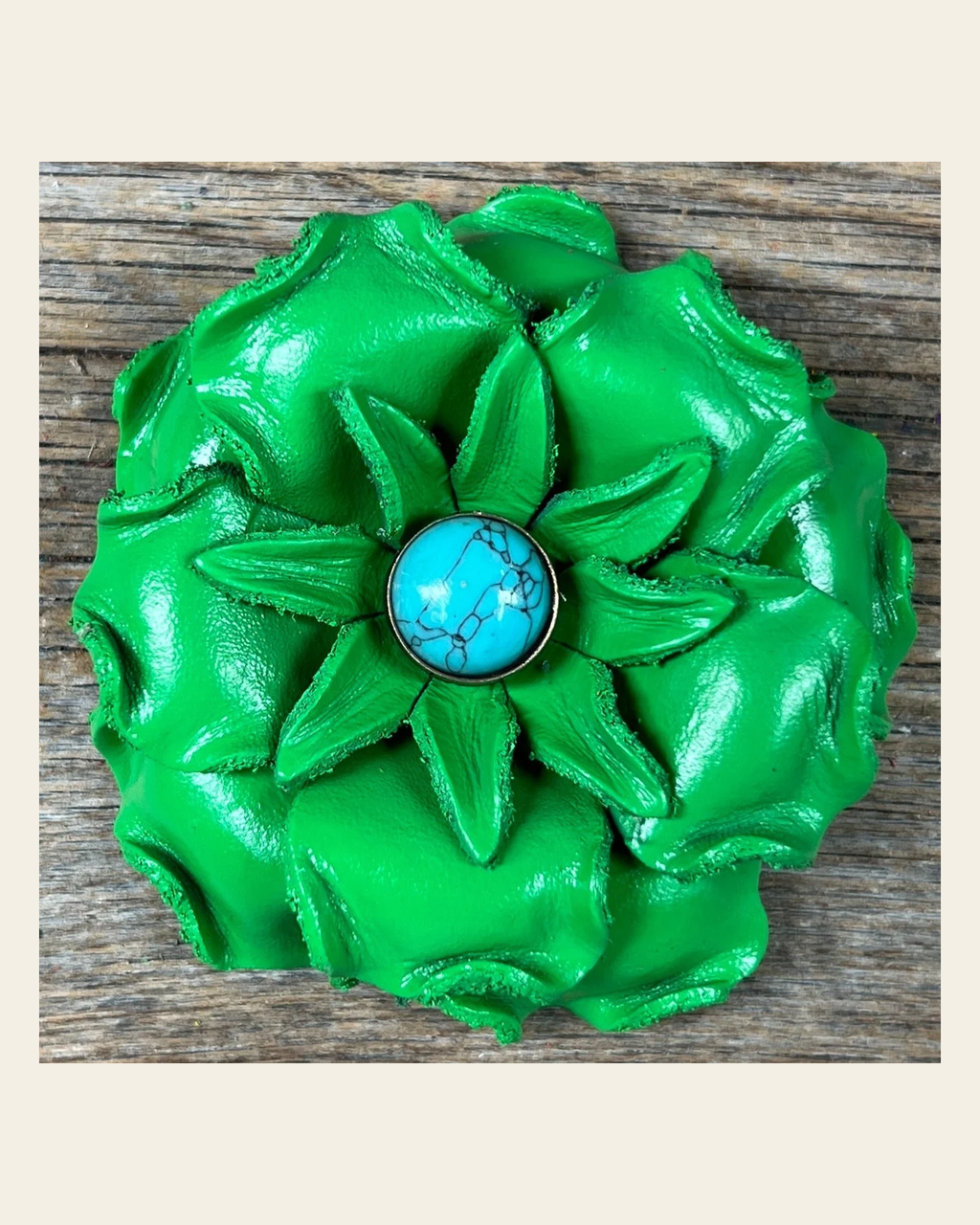 Neon Green Gardenia Flower With Round Turquoise Cabochon on a warm cream background