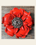 Neon Orange Gardenia Flower With Antique Silver Clear 1" Concho on a warm cream background