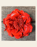 Neon Orange Gardenia Leather Flower on a warm cream background