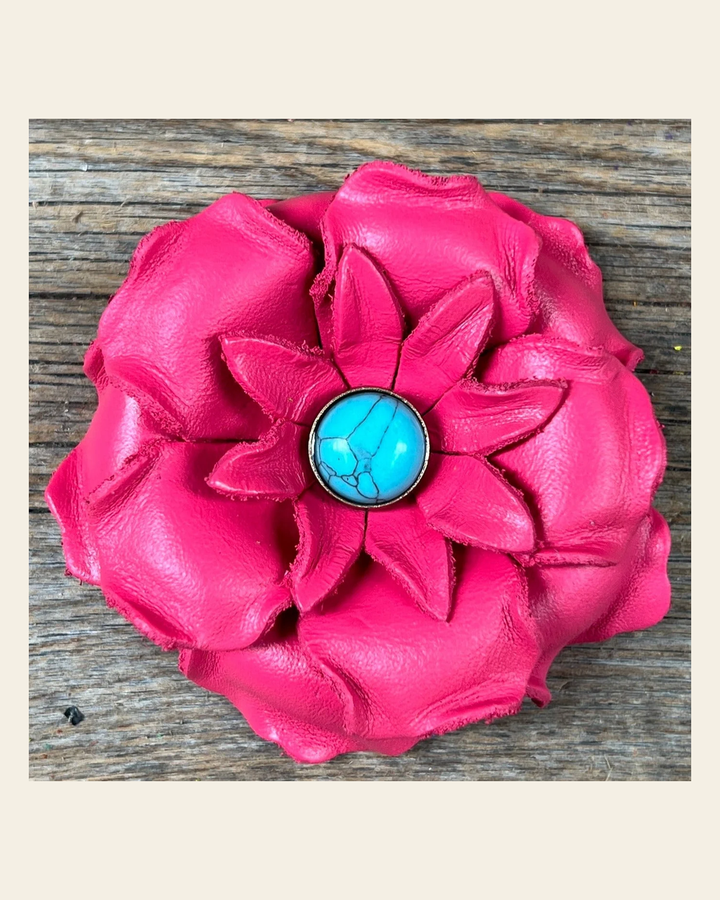 Neon Pink Gardenia Flower With Round Turquoise Cabochon on a warm cream background