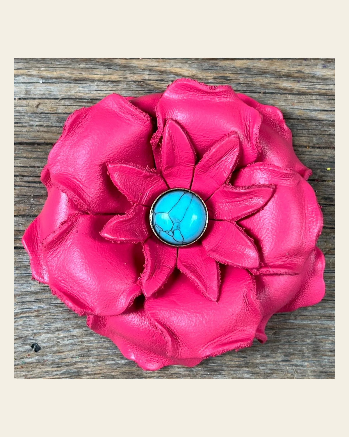 Neon Pink Gardenia Flower With Round Turquoise Cabochon on a warm cream background