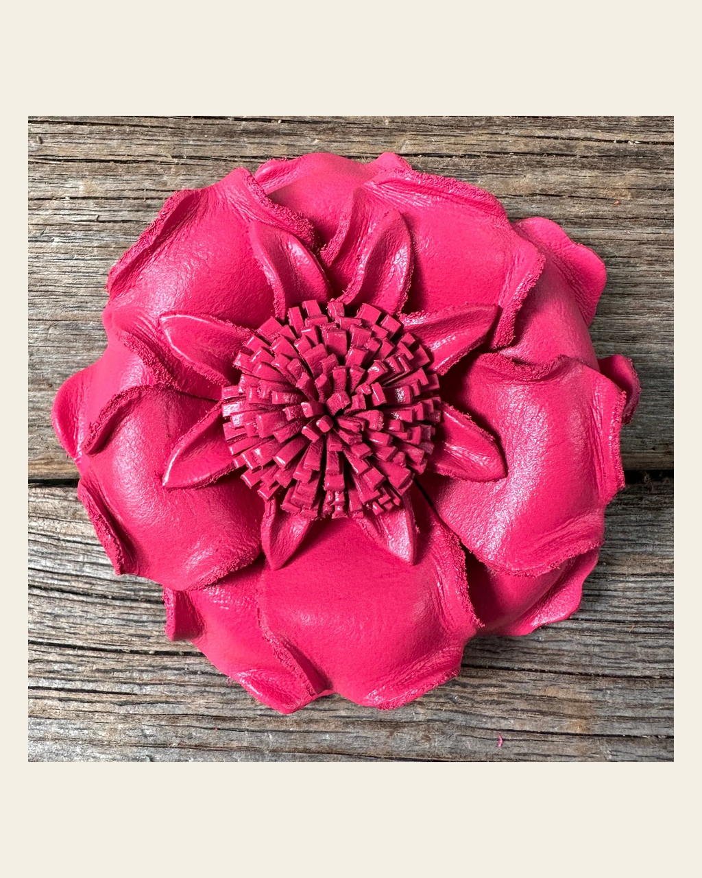 Neon Pink Gardenia Leather Flower on a warm cream background