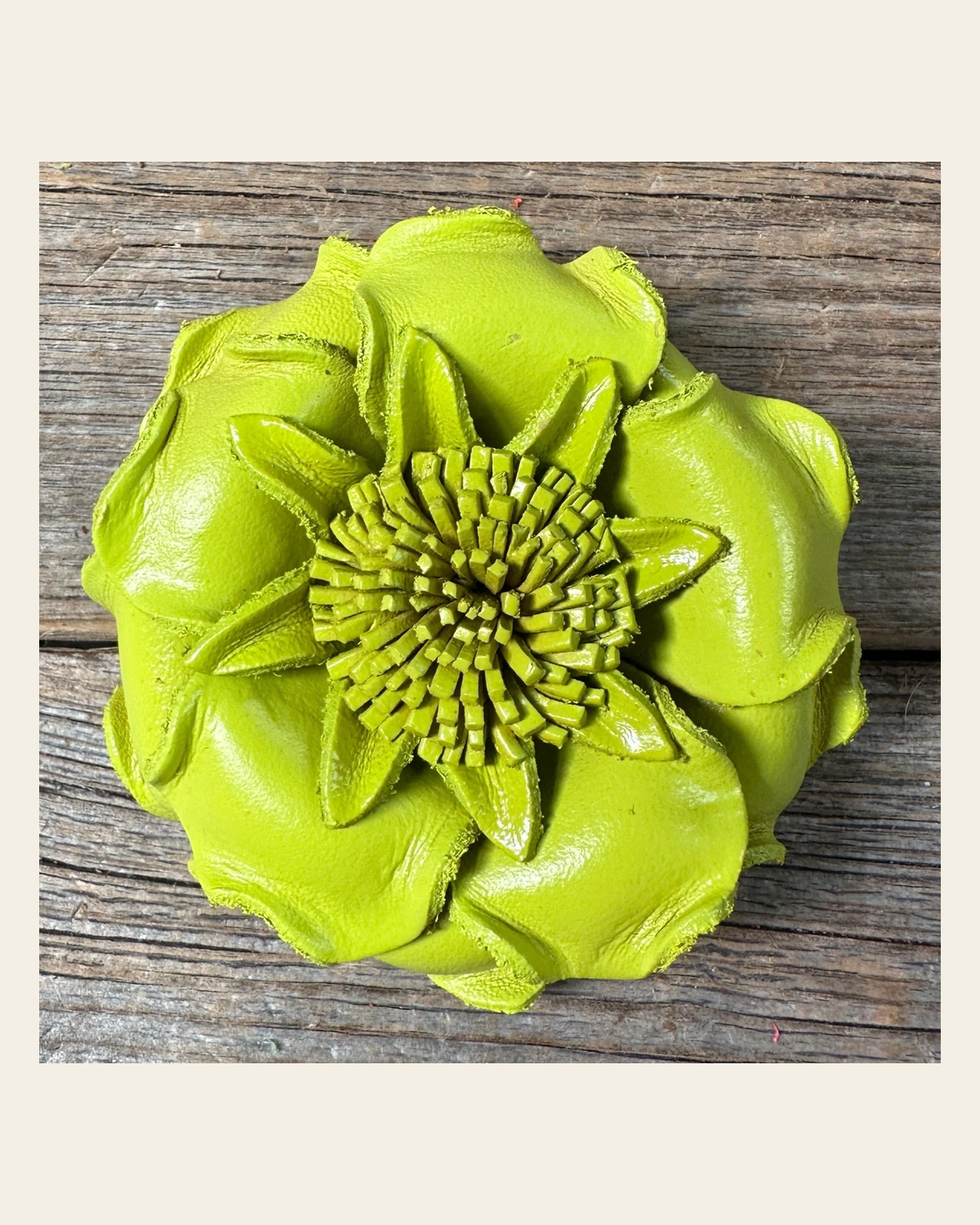 Neon Lime Gardenia Leather Flower on a warm cream background