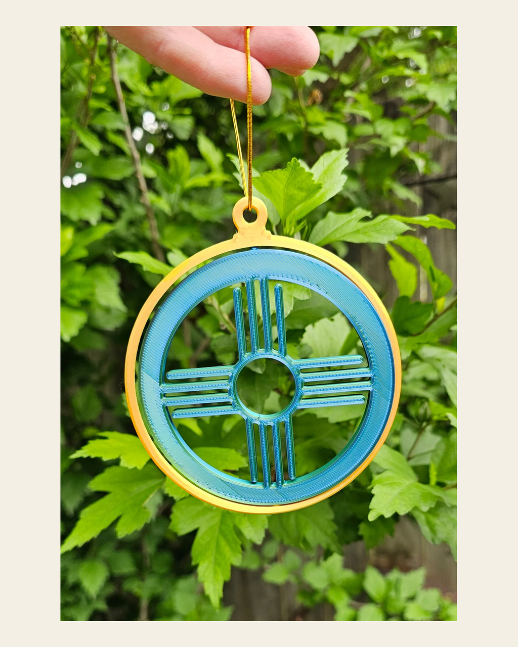 New Mexico Zia Ornament Large on a warm cream background