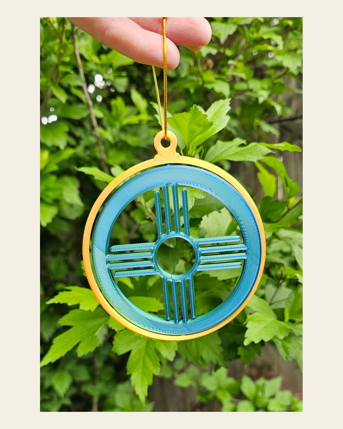 New Mexico Zia Ornament Large on a warm cream background