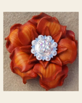 Orange Gardenia Flower With Bright Silver AB 1" Concho on a warm cream background