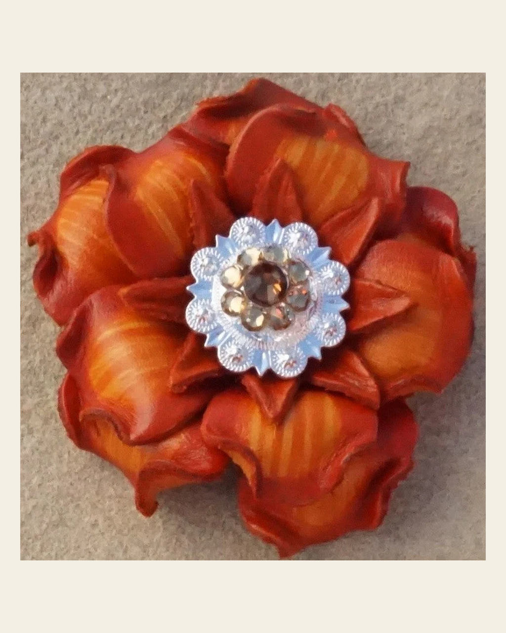 Orange Gardenia Flower With Bright Silver Topaz and Champagne 1" Concho on a warm cream background