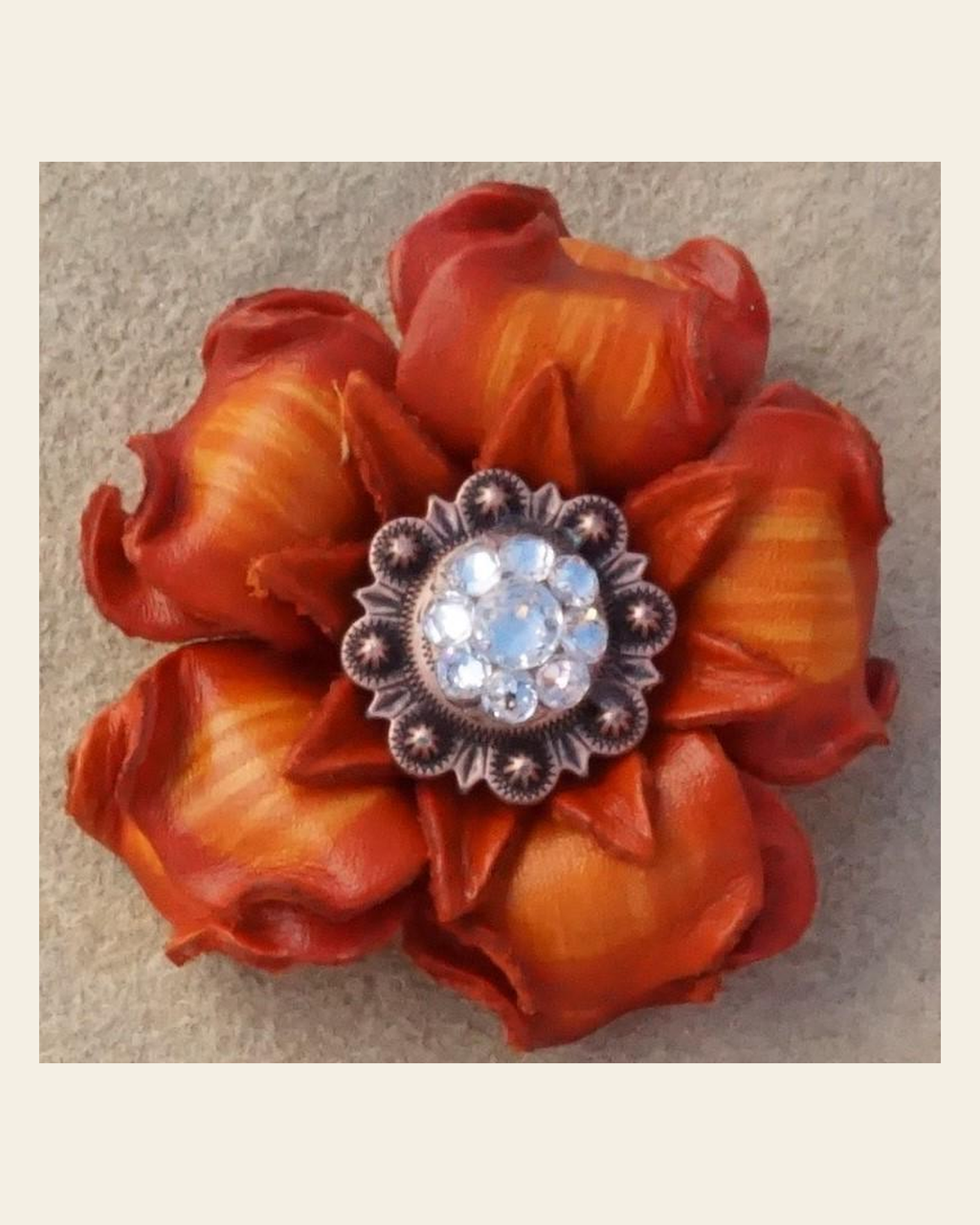 Orange Gardenia Flower With Copper Clear 1" Concho on a warm cream background