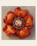 Orange Gardenia Flower With Copper Fire Opal and Clear 1" Concho on a warm cream background