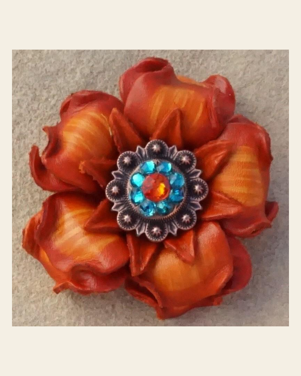 Orange Gardenia Flower With Copper Fire Opal & Teal 1" Concho on a warm cream background