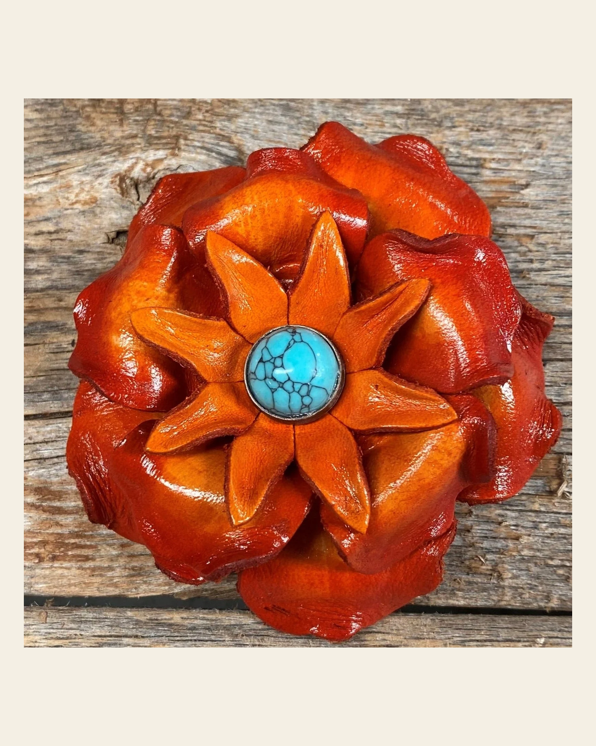 Orange Gardenia Flower With Round Turquoise Cabochon on a warm cream background