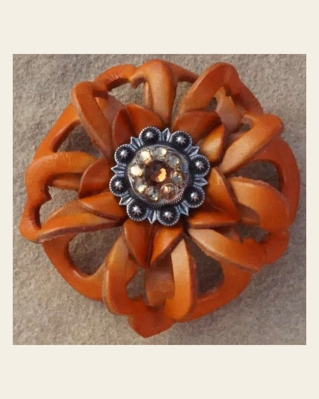 Orange Lotus Flower With Antique Silver Topaz/Champagne 1" Concho on a warm cream background