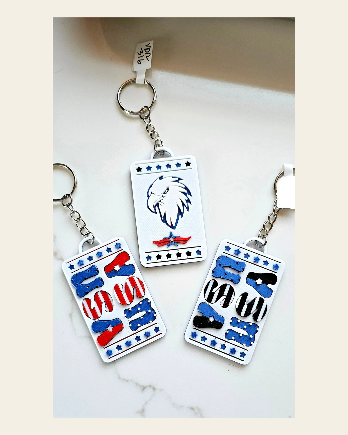 Patriotic Keychain - choice of styles - 3D Print USA - Made in America on a warm cream background