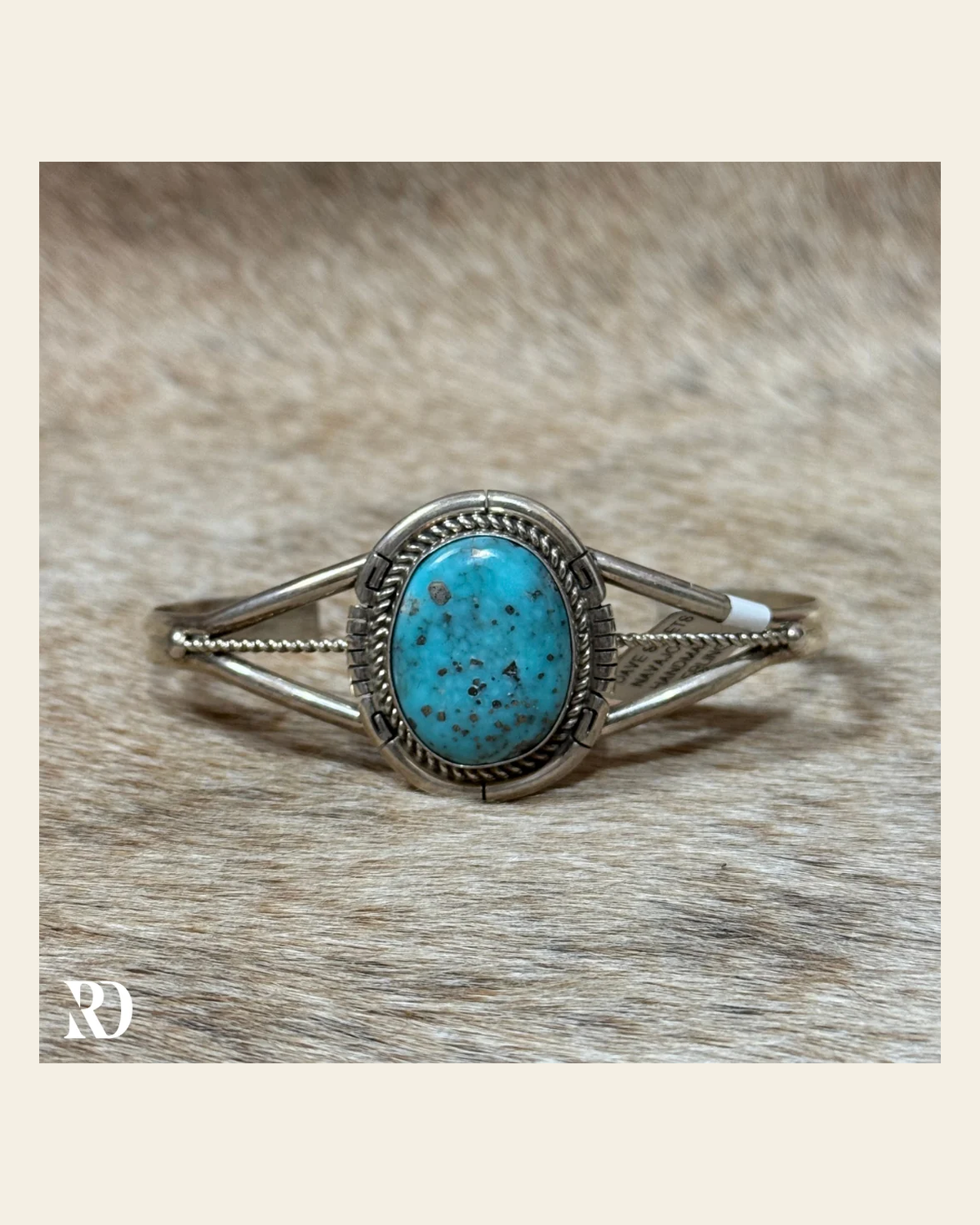 Prince Turquoise Cuff By Dave Skeets on a warm cream background