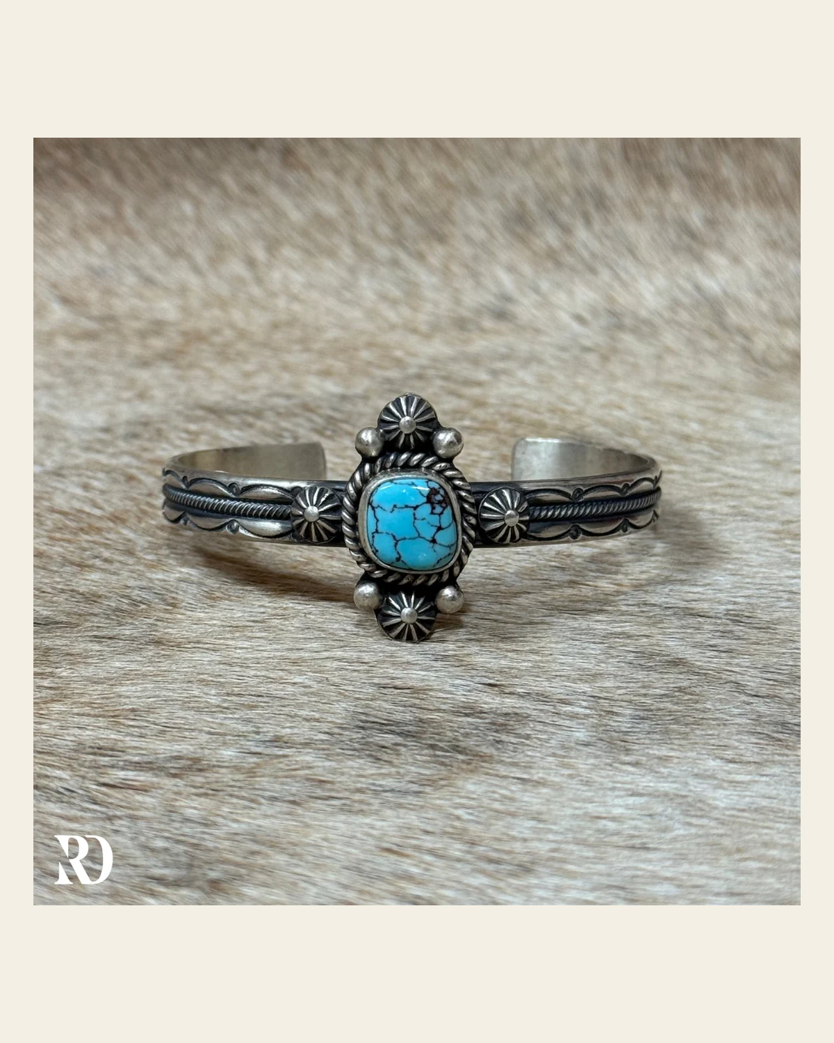 Prince Turquoise Cuff By Mike Caladito on a warm cream background