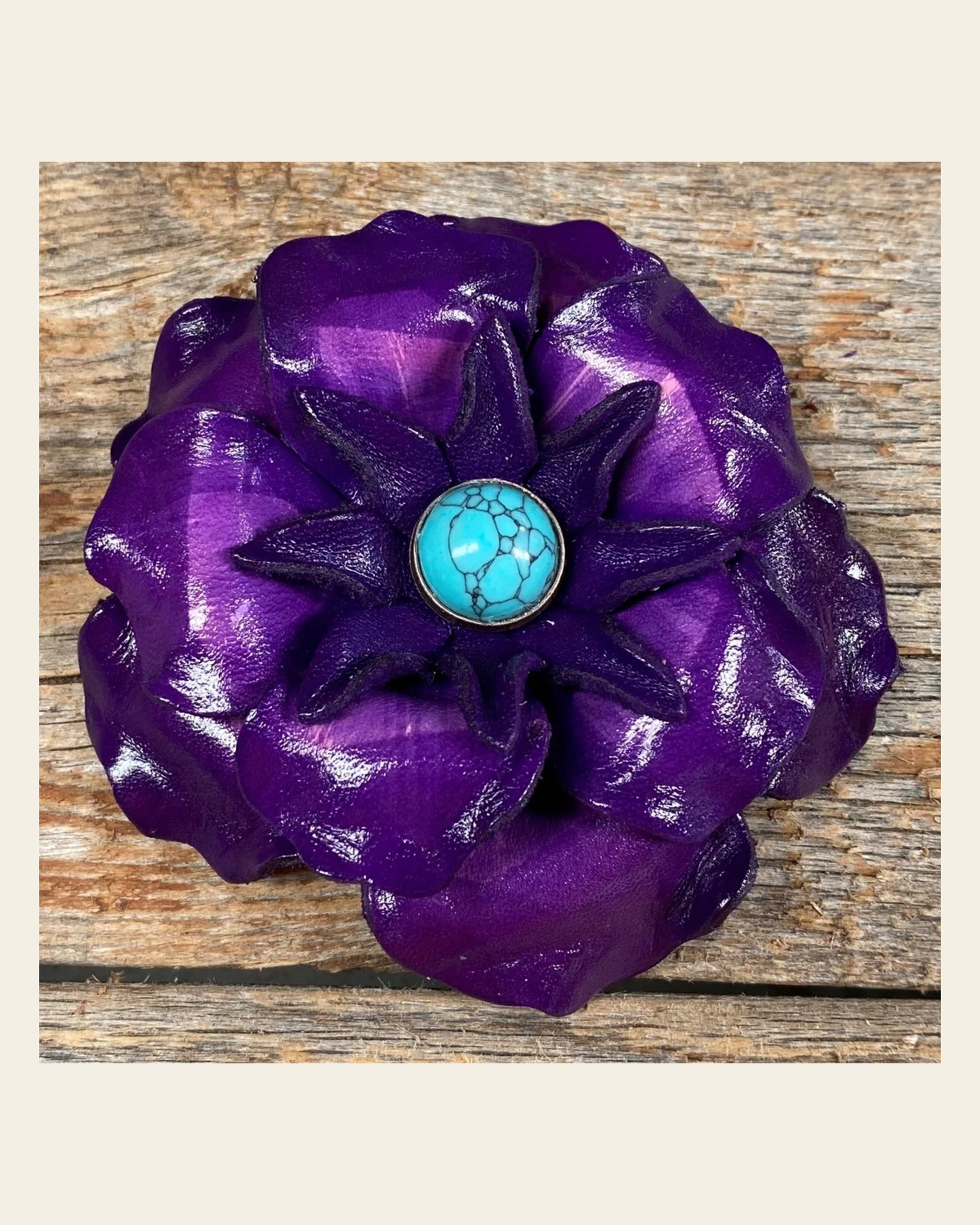 Purple Gardenia Flower With Round Turquoise Cabochon on a warm cream background