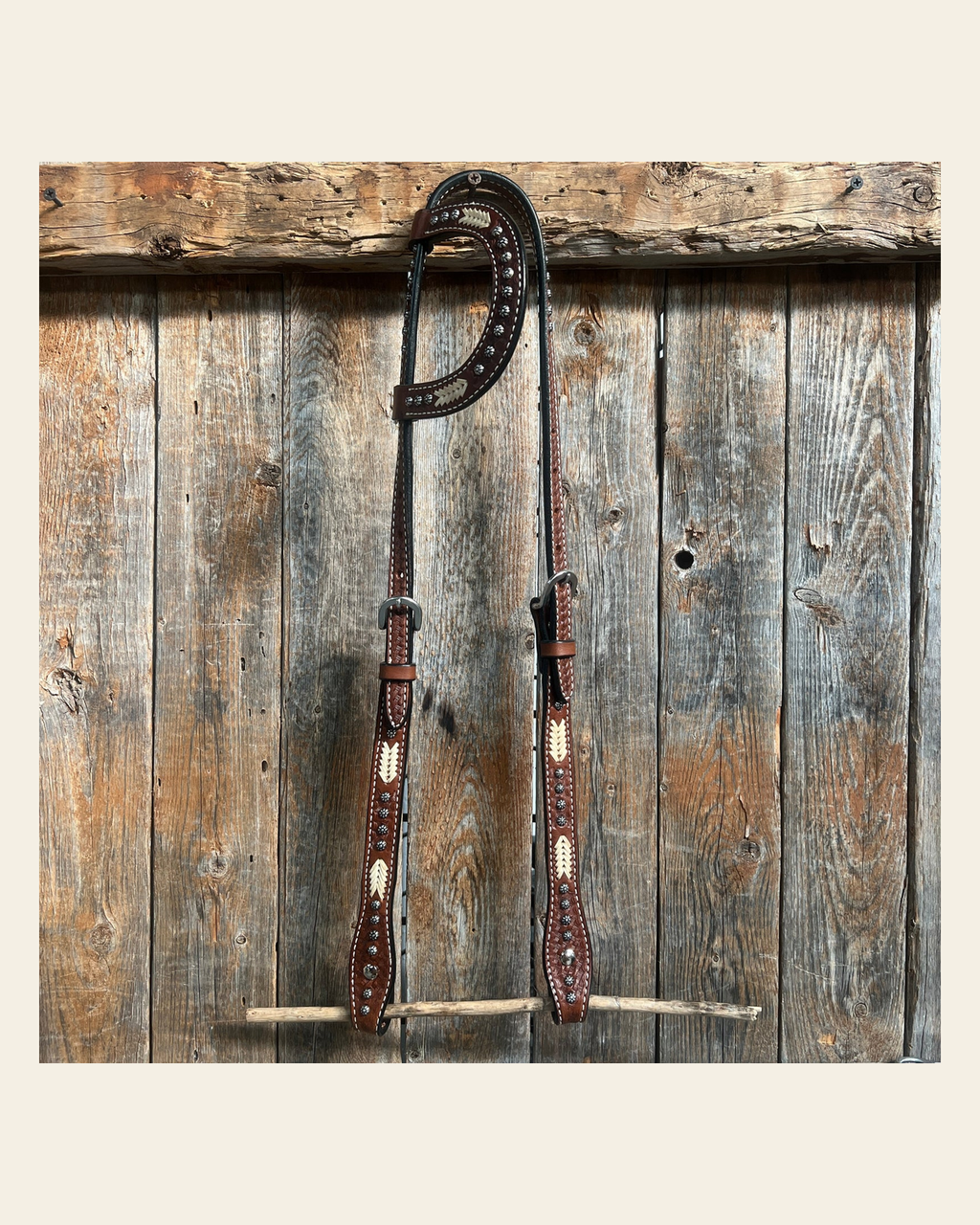 Rawhide One Ear Headstall / Bridle on a warm cream background