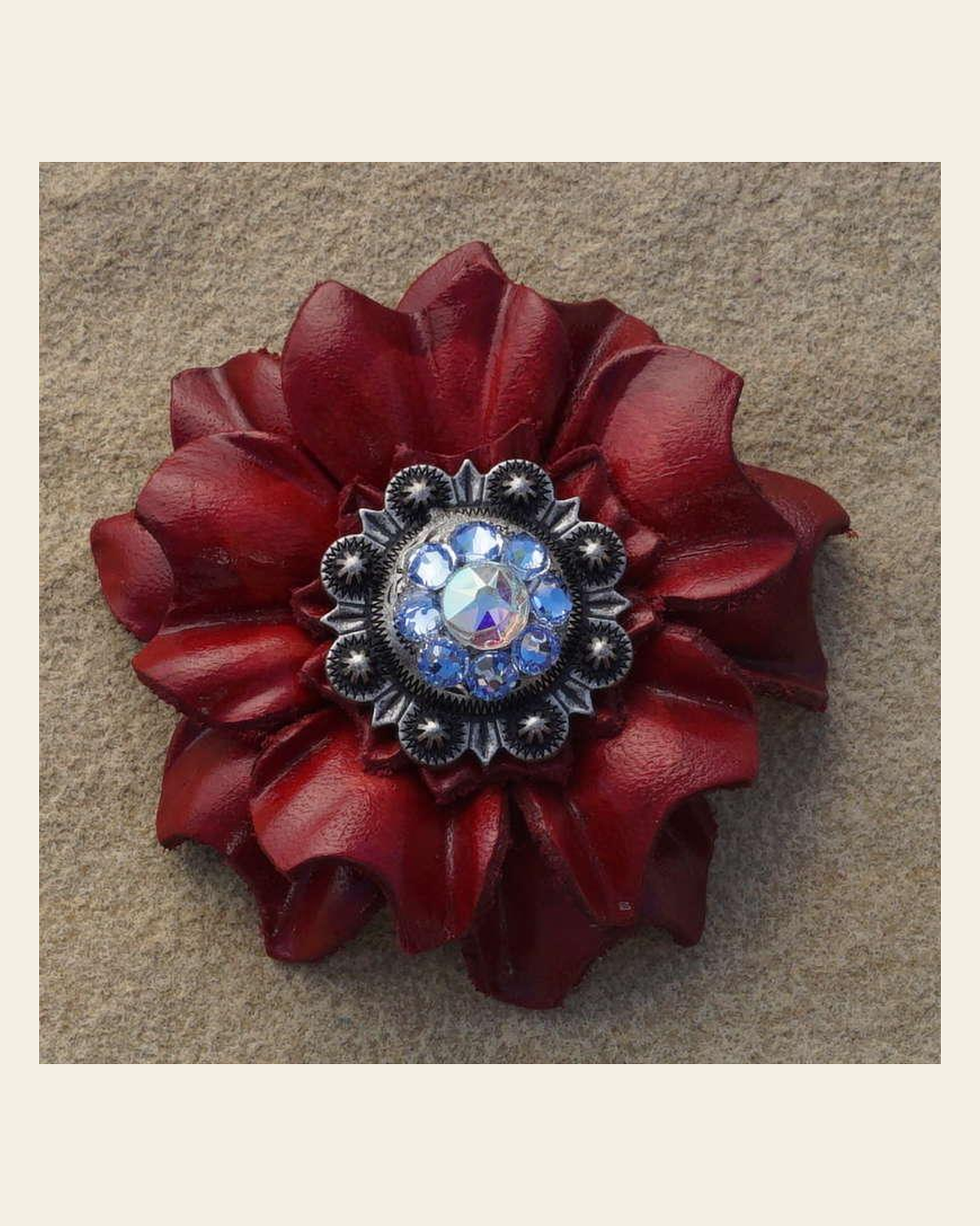 Red Carnation Flower With Antique Silver Light Sapphire and AB 1" Concho on a warm cream background