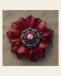 Red Carnation Flower With Antique Silver Ruby and AB 1" Concho on a warm cream background
