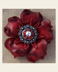 Red Gardenia Flower With Antique Silver Ruby and AB 1" Concho on a warm cream background