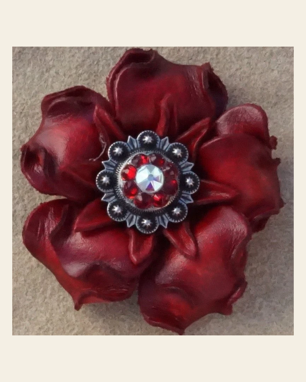 Red Gardenia Flower With Antique Silver Ruby and AB 1" Concho on a warm cream background