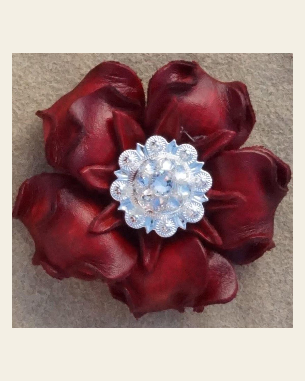 Red Gardenia Flower With Bright Silver Clear 1" Concho on a warm cream background