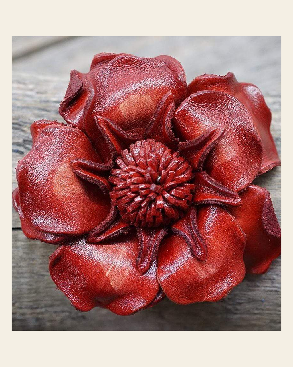 Red Gardenia Leather Flower on a warm cream background