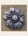 Silver Carnation Flower With Antique Silver AB 1" Concho on a warm cream background