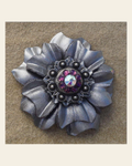 Silver Carnation Flower With Antique Silver Amethyst and AB 1" Concho on a warm cream background
