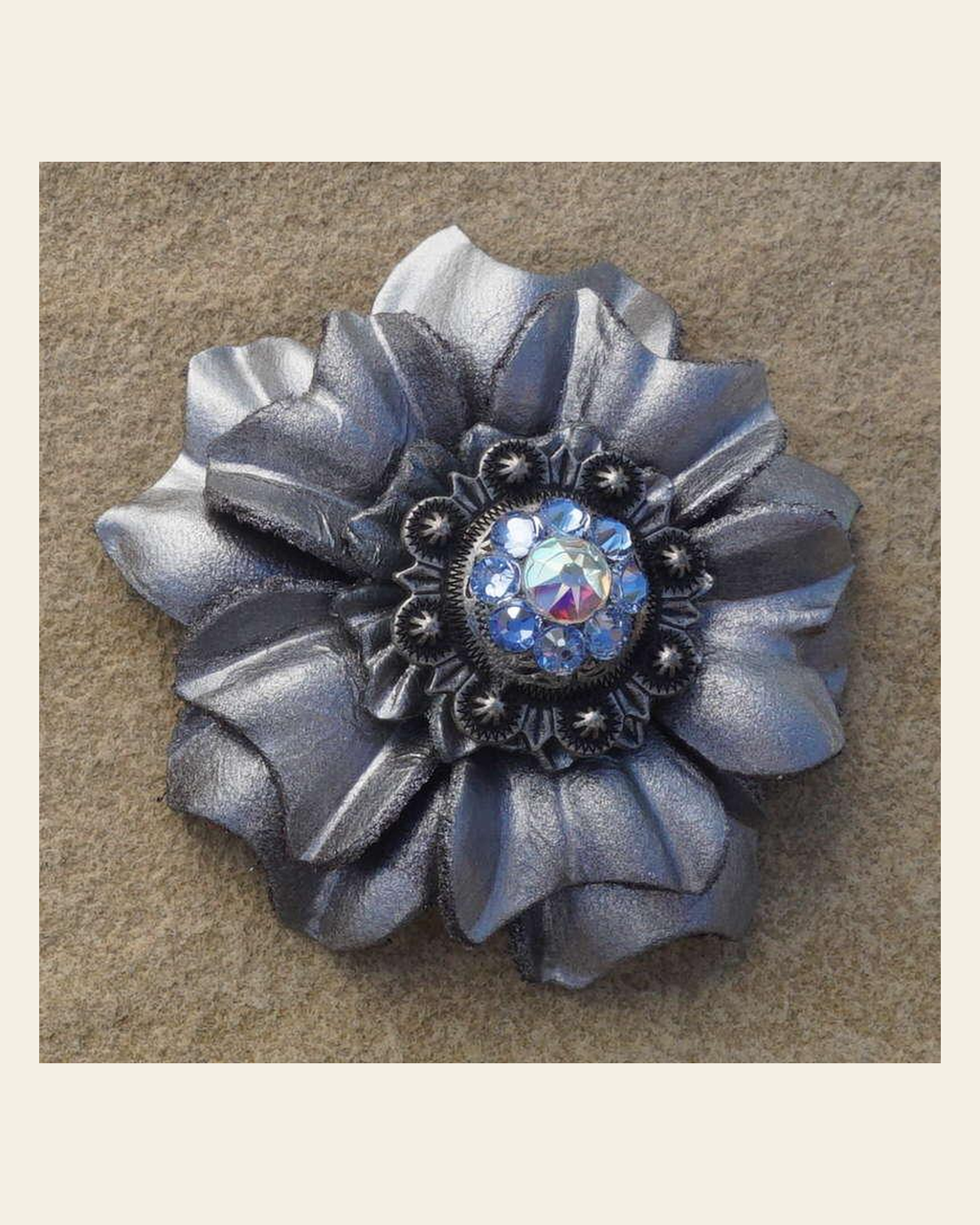 Silver Carnation Flower With Antique Silver Light Sapphire and AB 1" Concho on a warm cream background