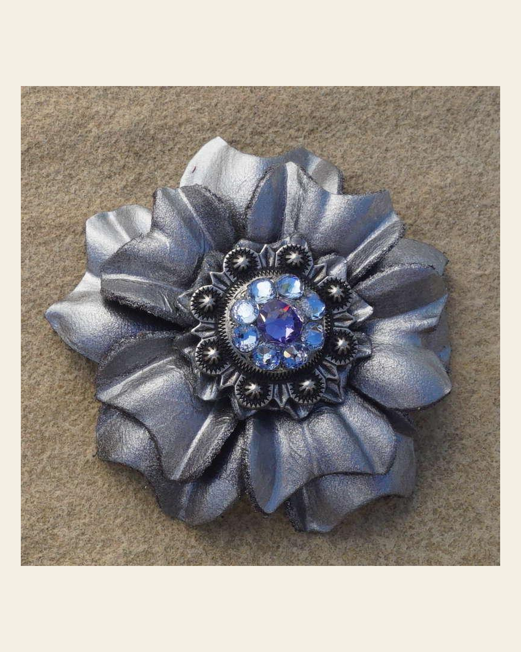 Silver Carnation Flower With Antique Silver Lilac and Light Sapphire 1" Concho on a warm cream background