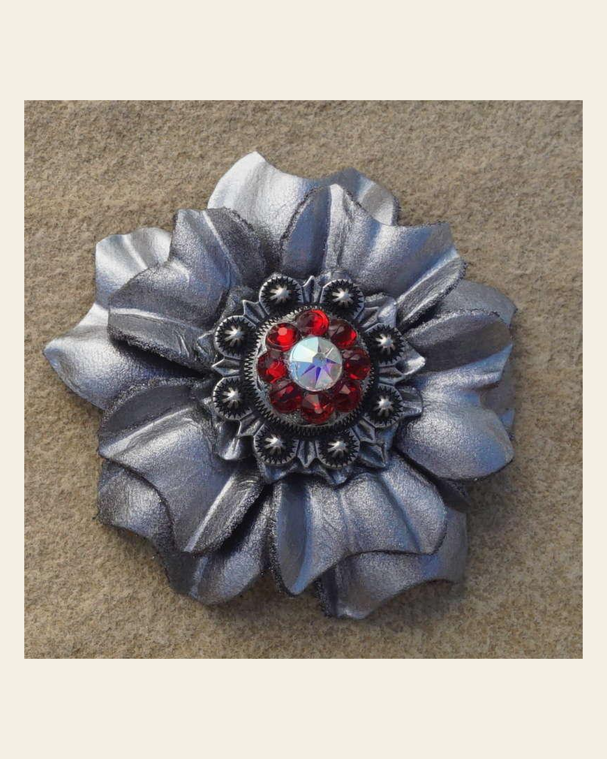 Silver Carnation Flower With Antique Silver Ruby and AB 1" Concho on a warm cream background