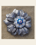 Silver Carnation Flower With Bright Silver Capri and AB 1" Concho on a warm cream background