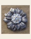 Silver Carnation Flower With Bright Silver Clear 1" Concho on a warm cream background