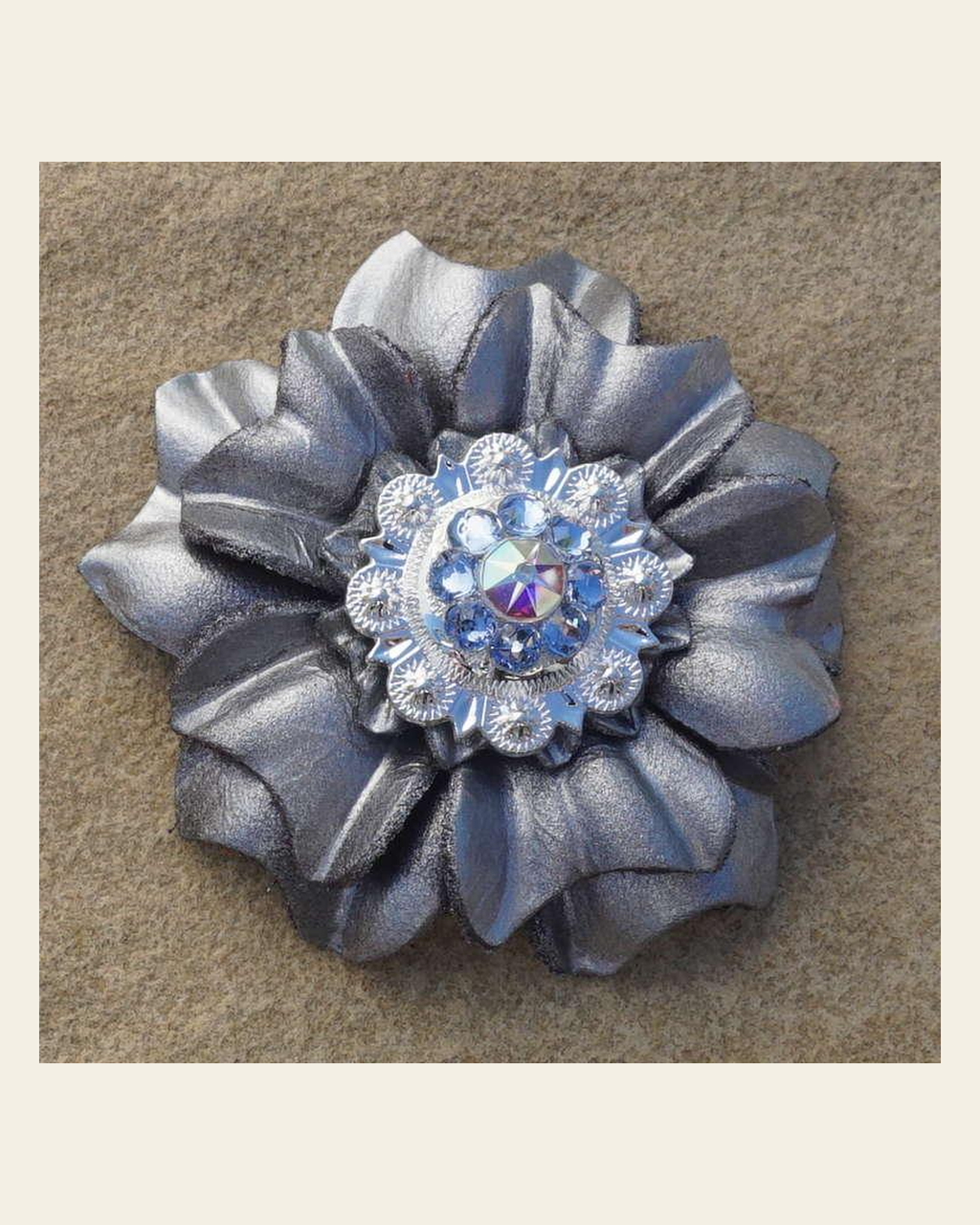 Silver Carnation Flower With Bright Silver Light Sapphire and AB 1" Concho on a warm cream background
